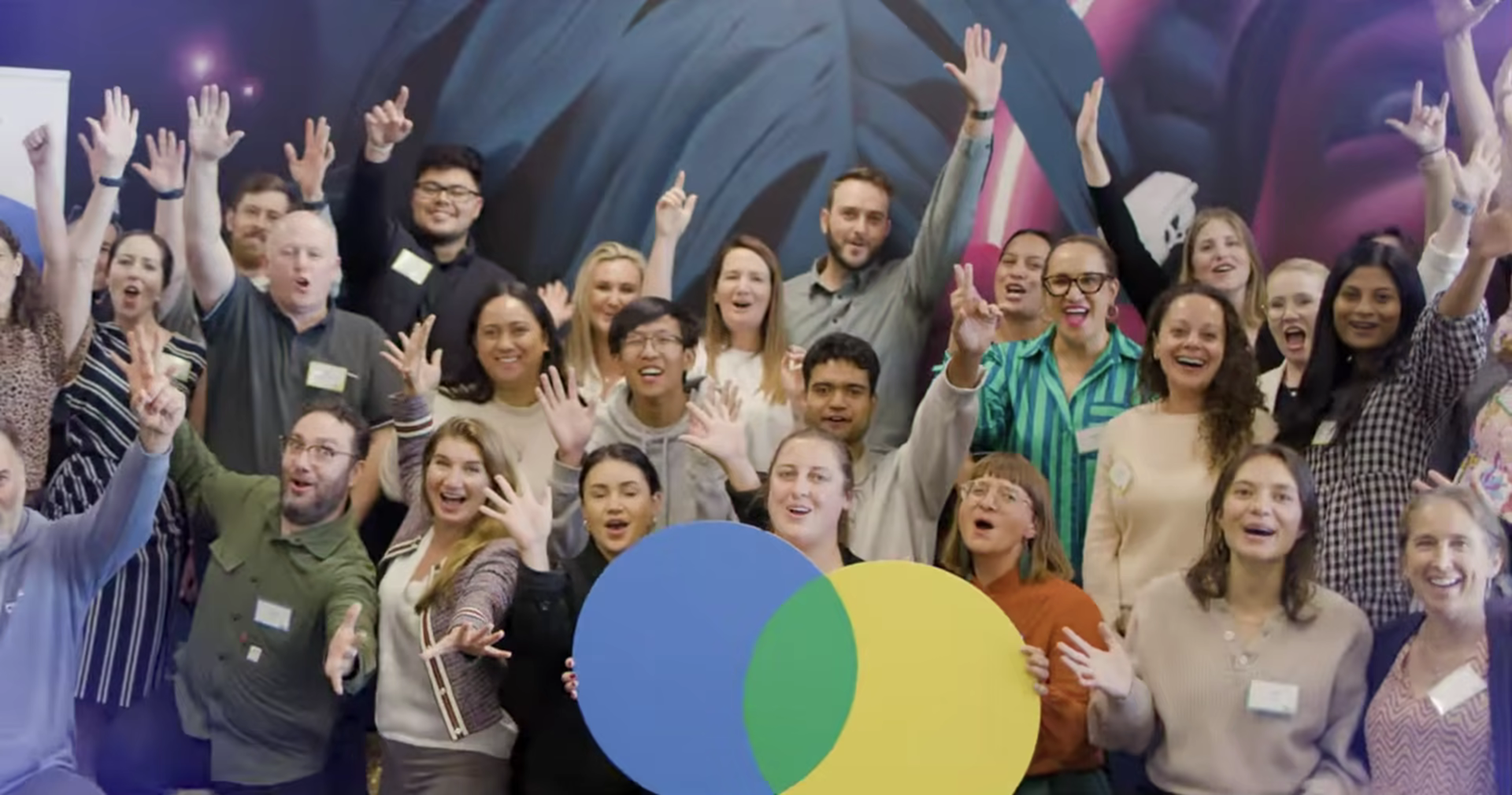 Everyone cheering Big Bloom at the close of the hackathon film